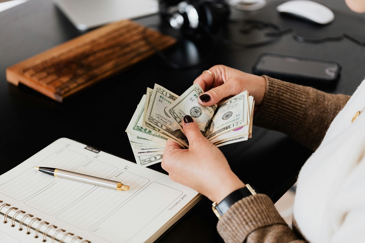 Photo {of a woman counting money) to illustrate Financial Control